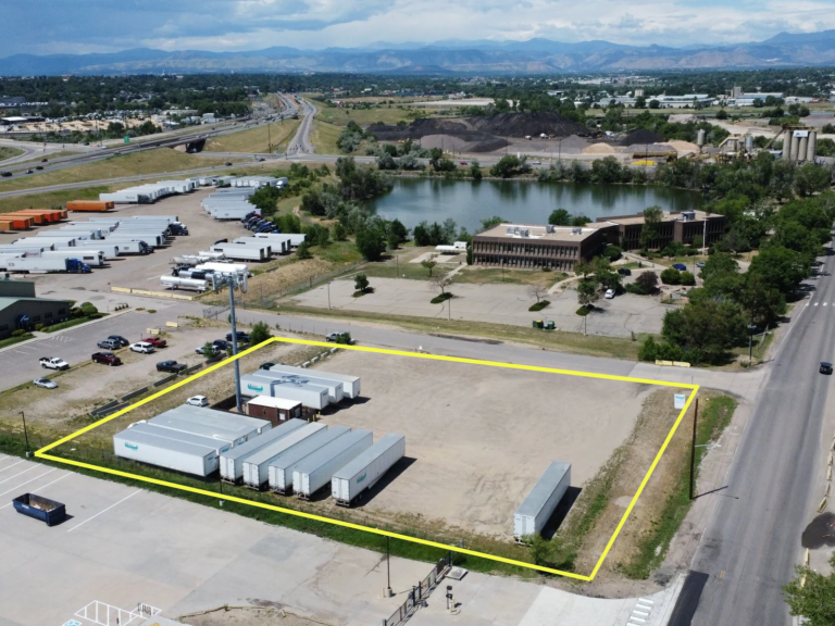Aerial view of 1280 W 64th Avenue in Unincorporated Adams County, Colorado, showing the 1.29-acre industrial land site outlined in yellow near I-76.