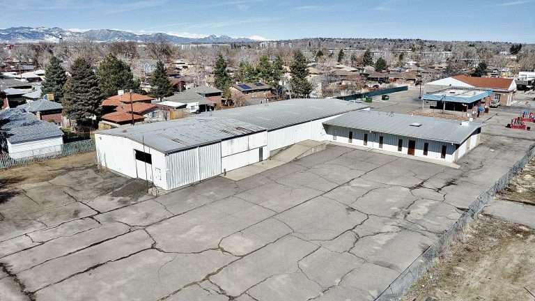 Aerial view of the industrial property at 5345 Marshall Street in Arvada, Colorado. The building is shown, in addition to the fenced yard.