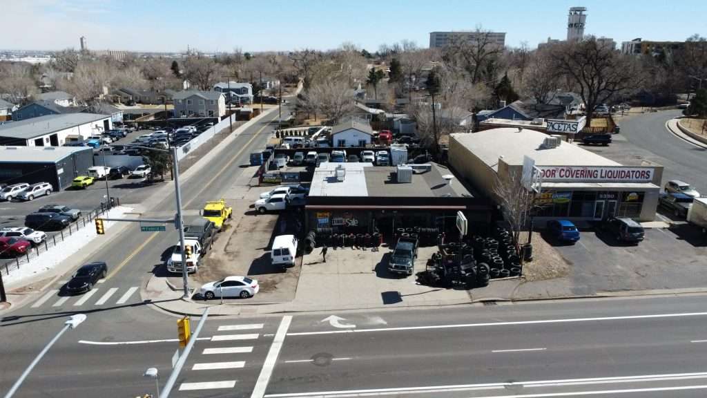 Corner lot tire shop for sale in Denver, Colorado with two curb cuts, ample parking and yard space